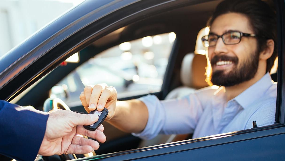 Man taking the keys to his new car