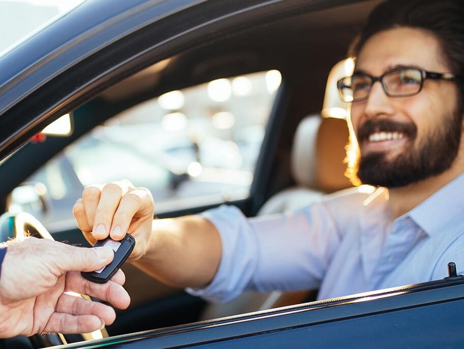 Man taking the keys to his new car