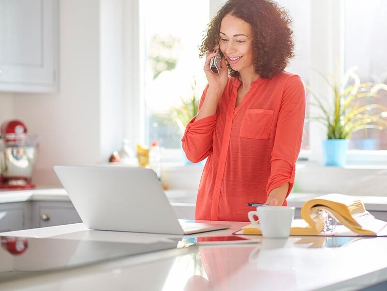 Woman on the phone in her kitchen