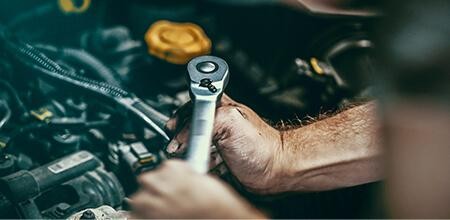 Service mechanic working on an engine