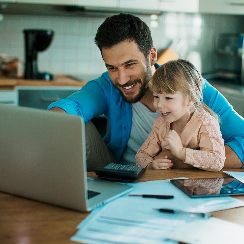 Father and daughter looking at a computer