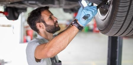 Service mechanic installing a vehicle tire