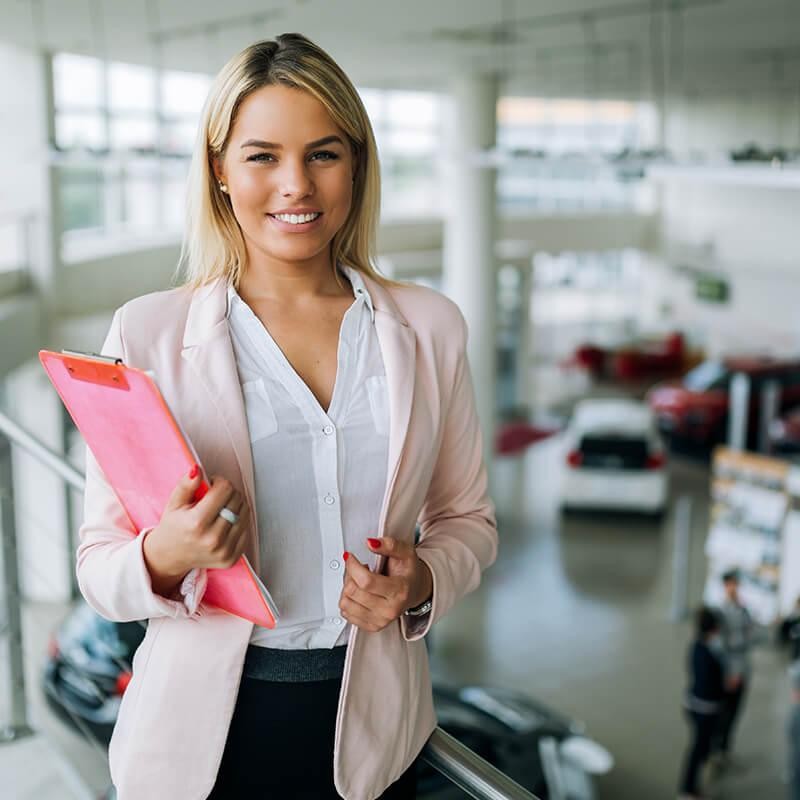 Dealership sales associate in a vehicle showroom