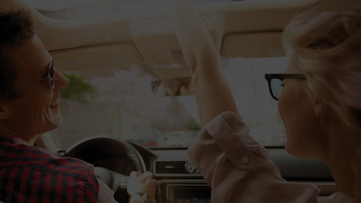 couple looking at each other inside car