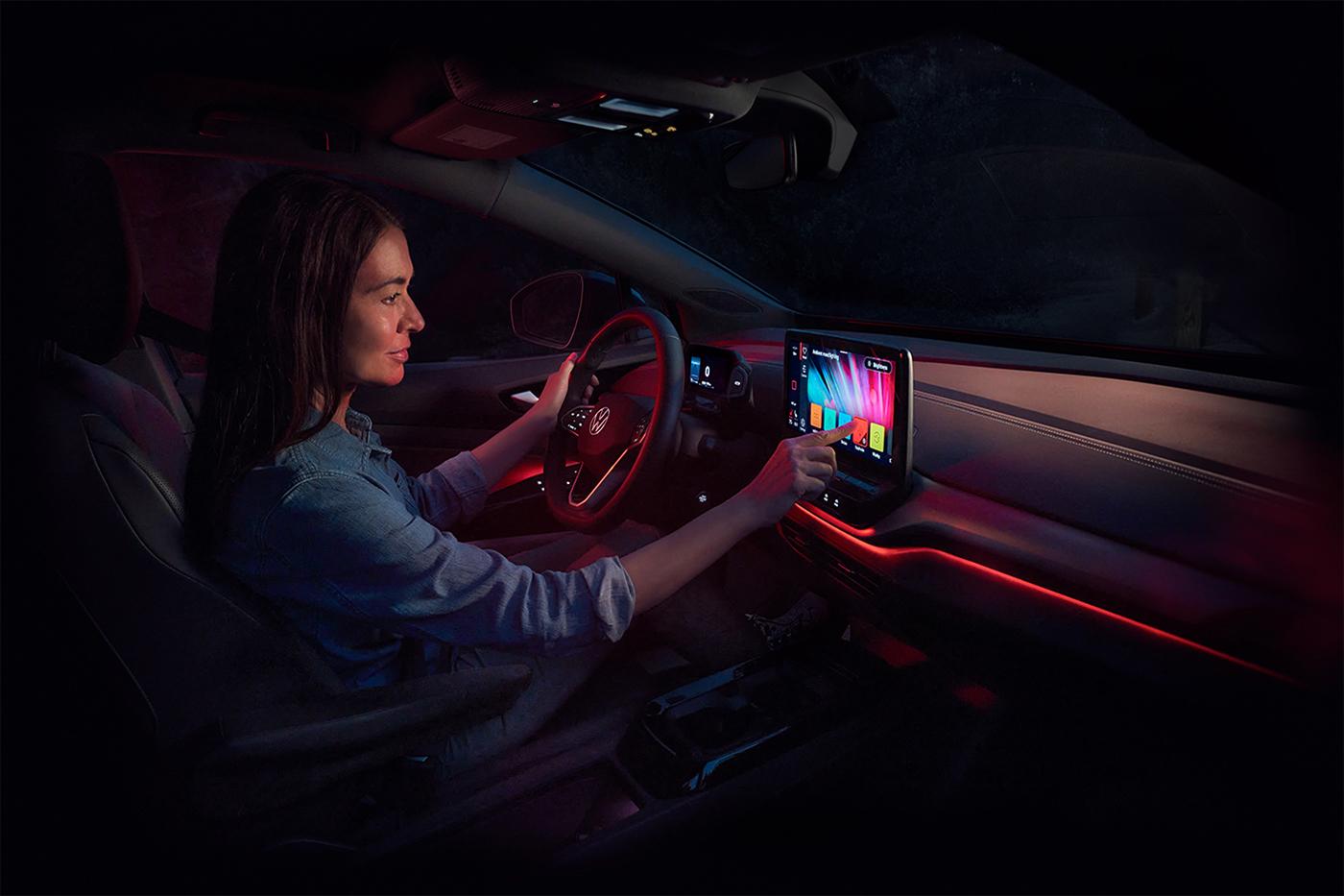 A woman adjusts the ambient lighting inside an ID.4.