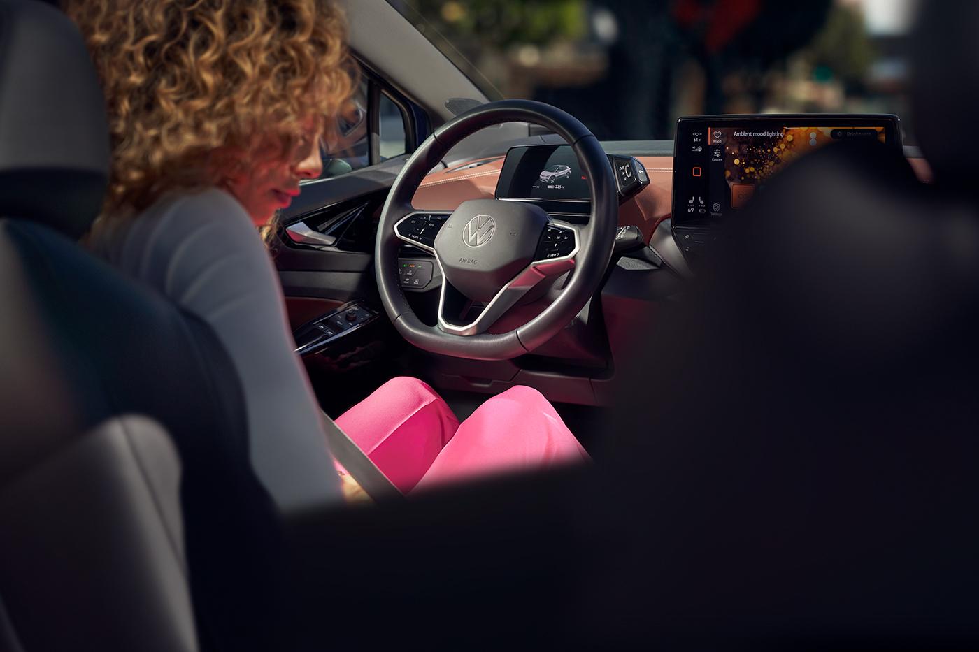 A woman sits in the driver’s seat of an ID.4