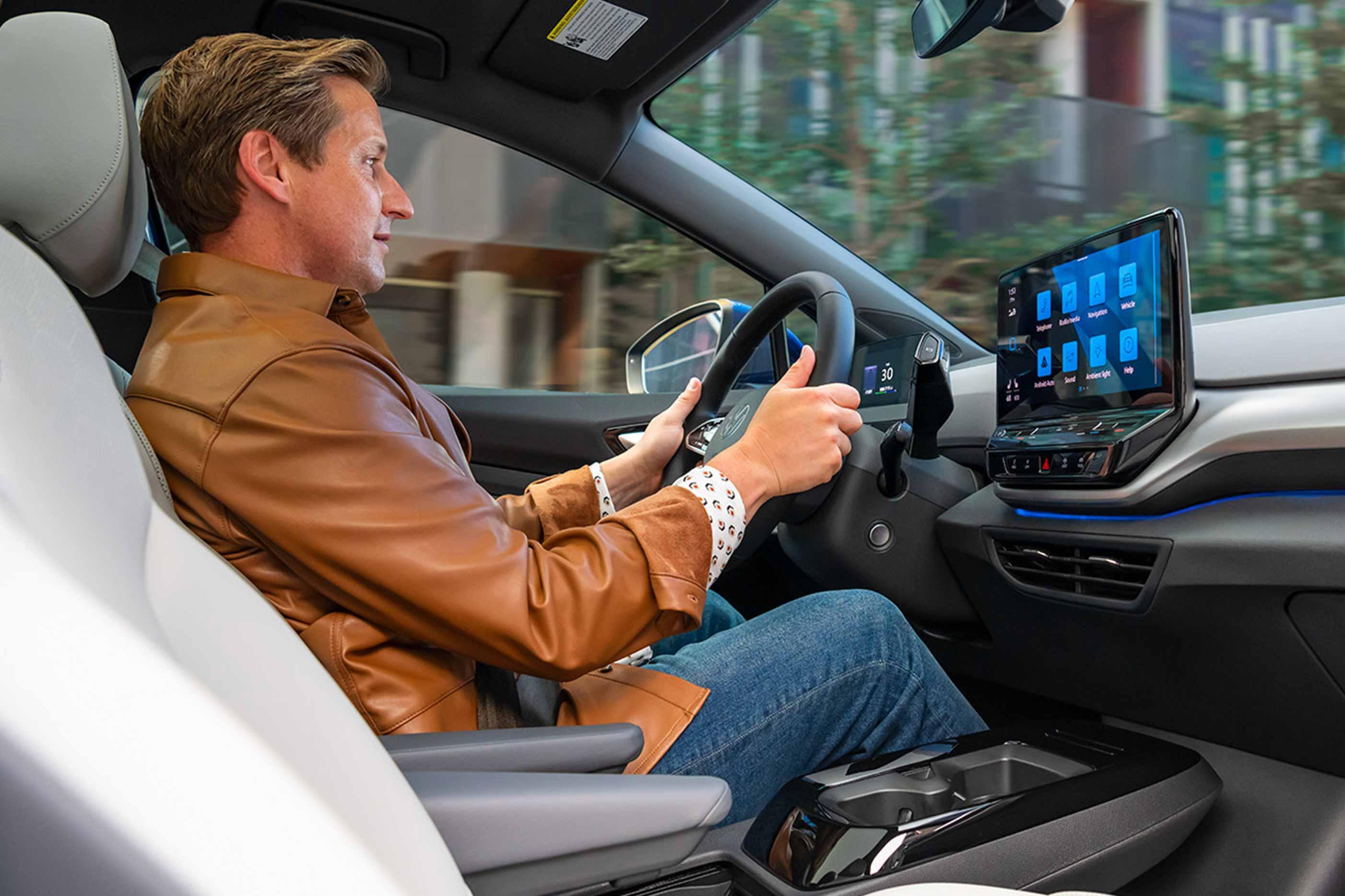 A shot of a man sitting in driver’s seat of an ID.4 with both hands on the steering wheel.