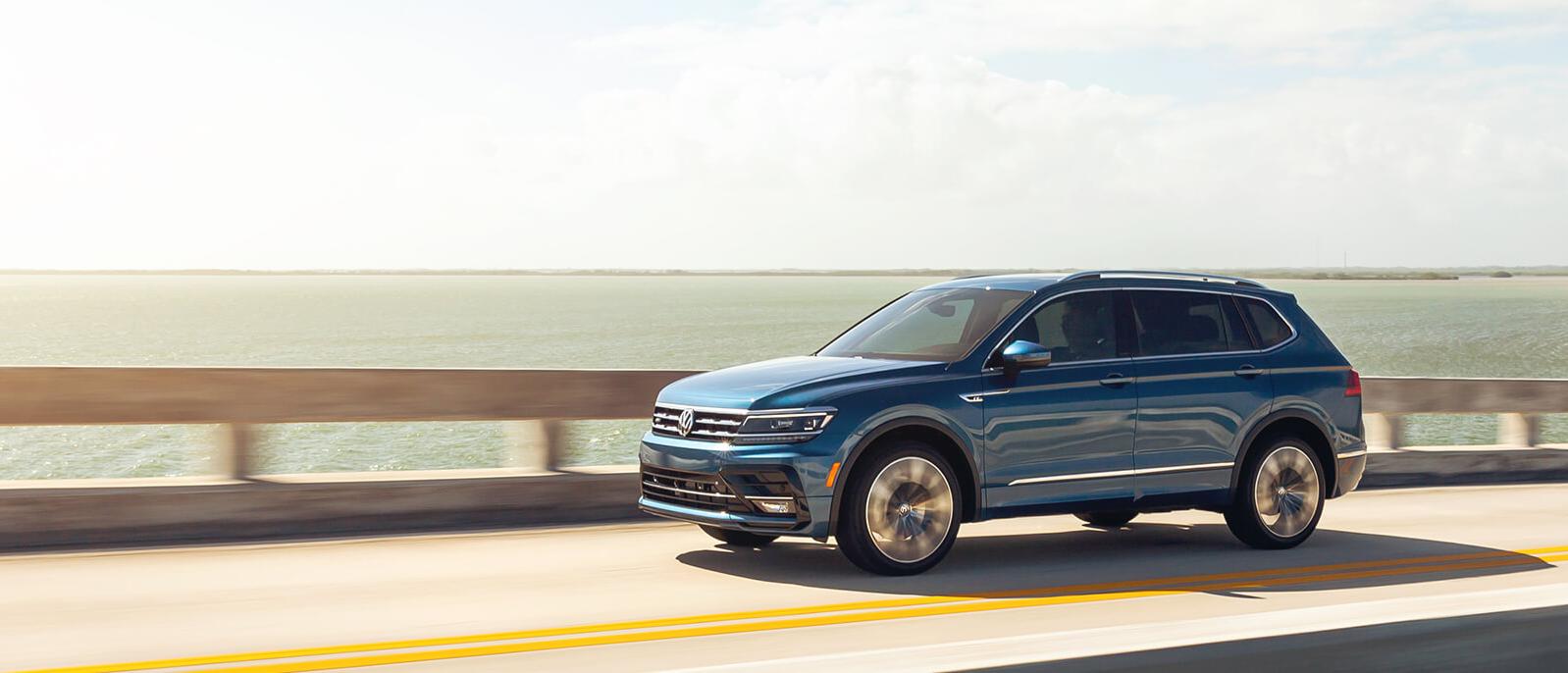 A Blue Tiguan driving on bridge A Blue Tiguan driving on bridge