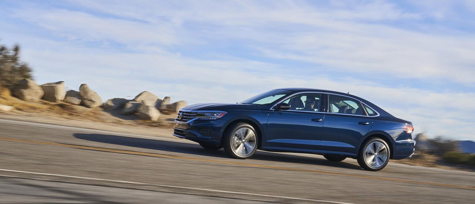 A Blue Passat driving on road A Blue Passat driving on road