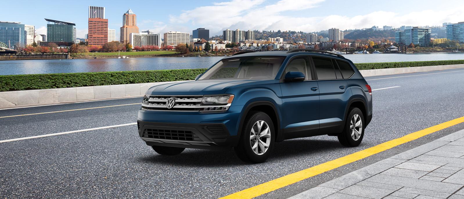 A blue Atlas is driving on the lake side road A blue Atlas is driving on the lake side road