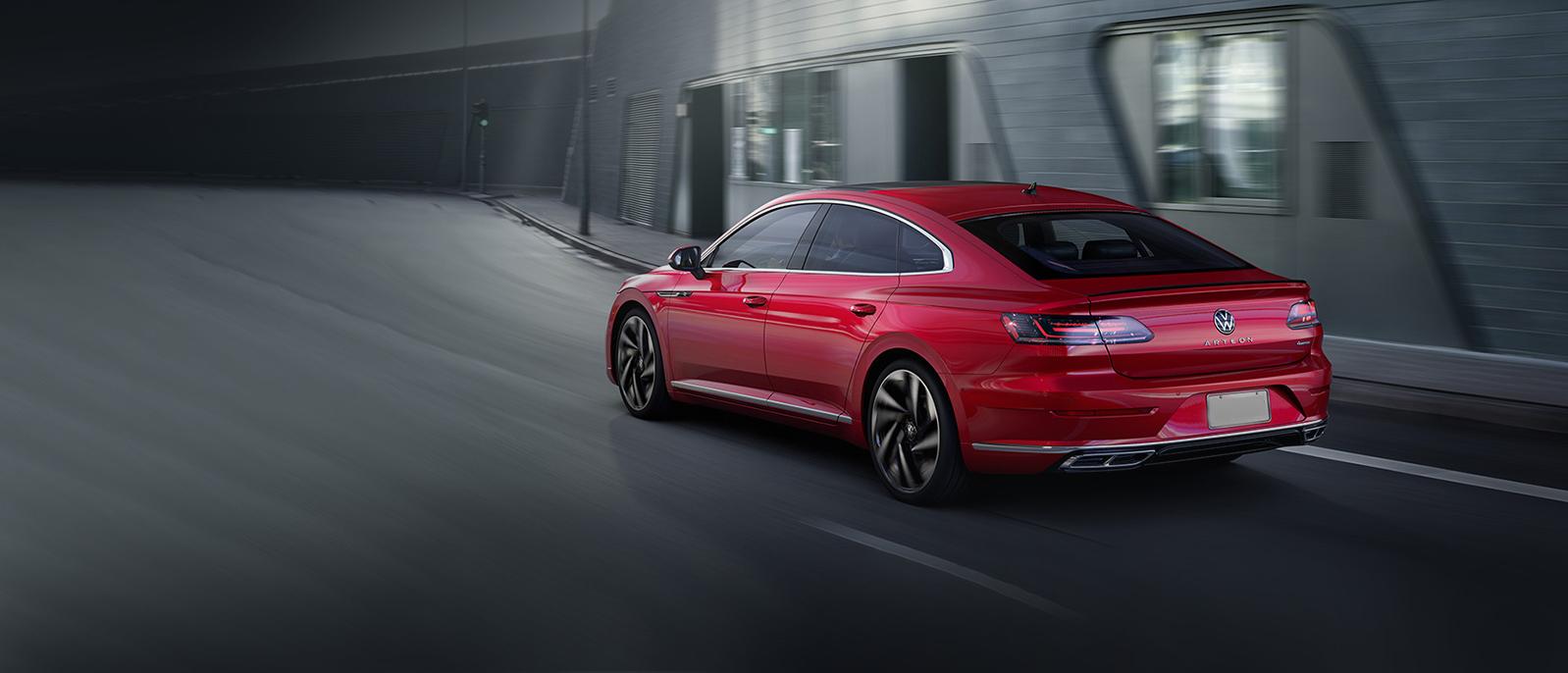 A red Arteon driving on the road. A red Arteon driving on the road.
