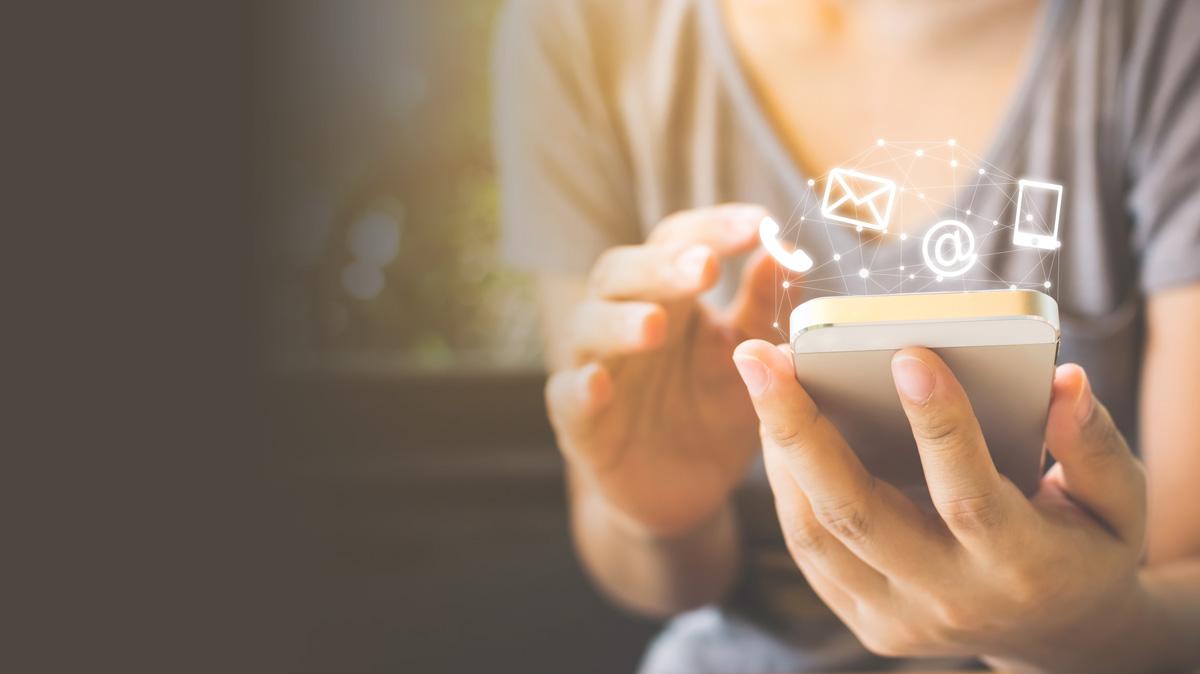 Woman on cell phone with contact icons above her phone Woman on cell phone with contact icons above her phone