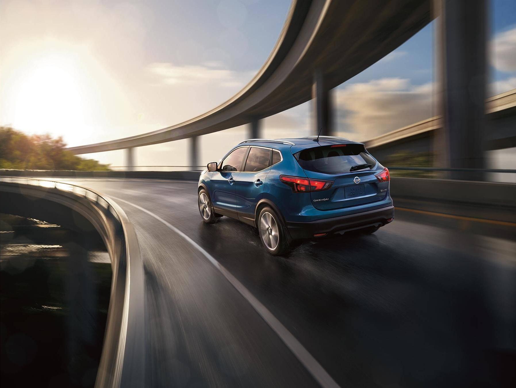 Nissan vehicle driving down the highway quickly