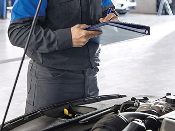 Service technician inspecting Ford vehicle