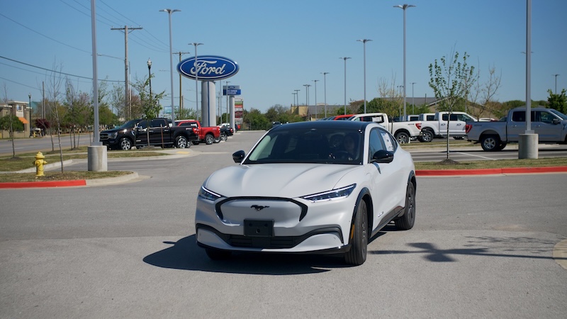 Front of white Ford Mustang Mach-E in dealership lot McLarty Daniel