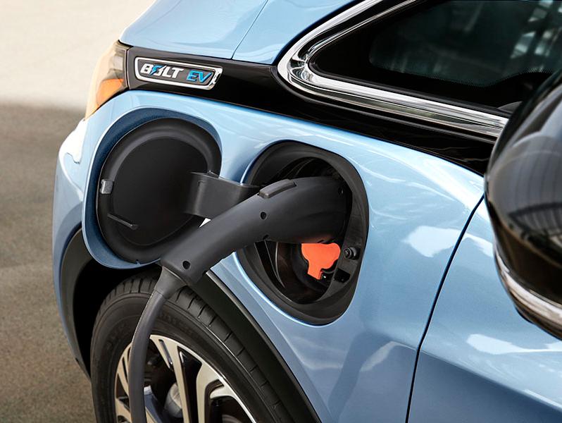 A charger plugged in to a Chevrolet bolt.
