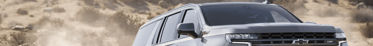 A new three-row SUV, the Chevy Suburban is driving off-road.