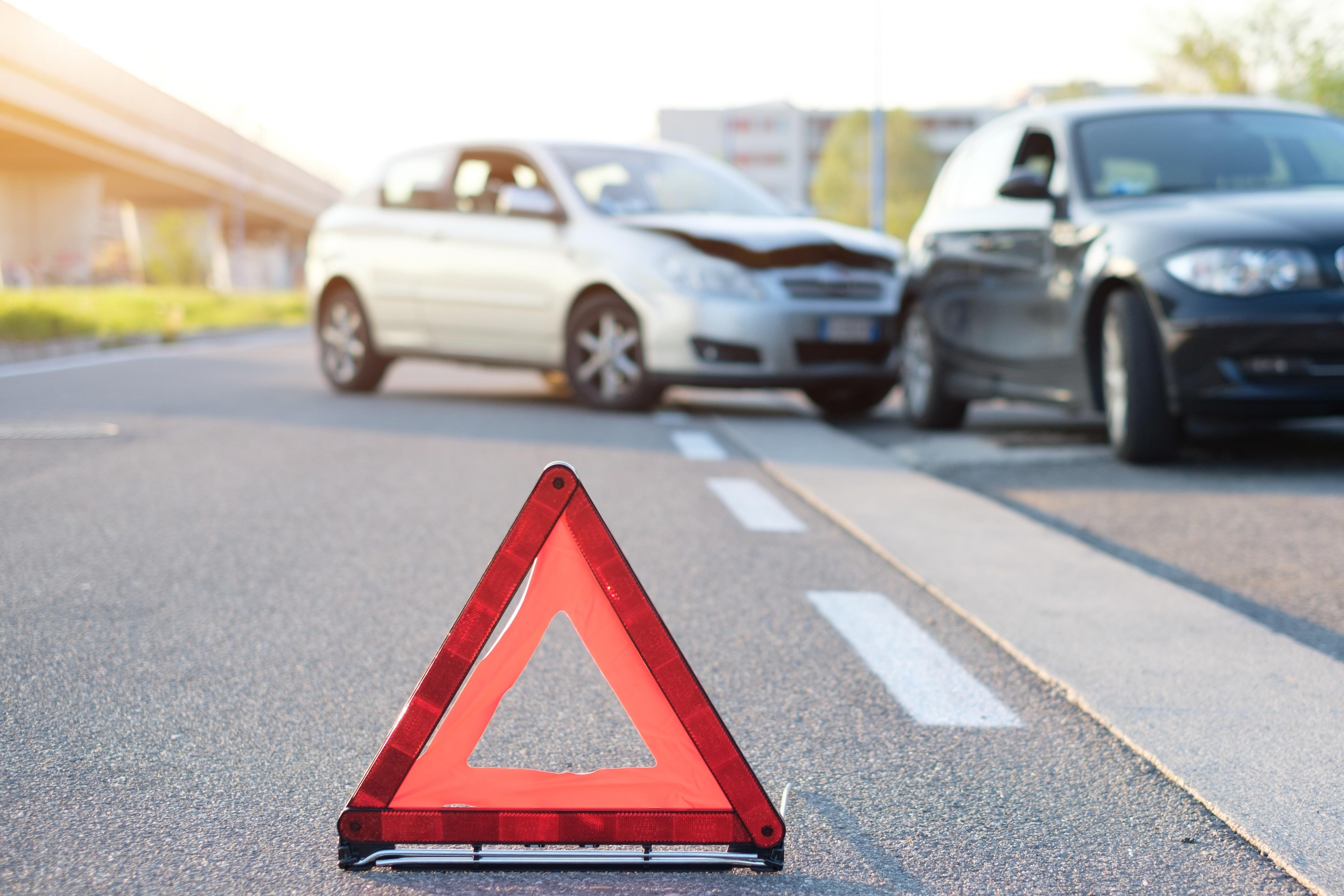 Image of a caution triangle blocking a roadside accident