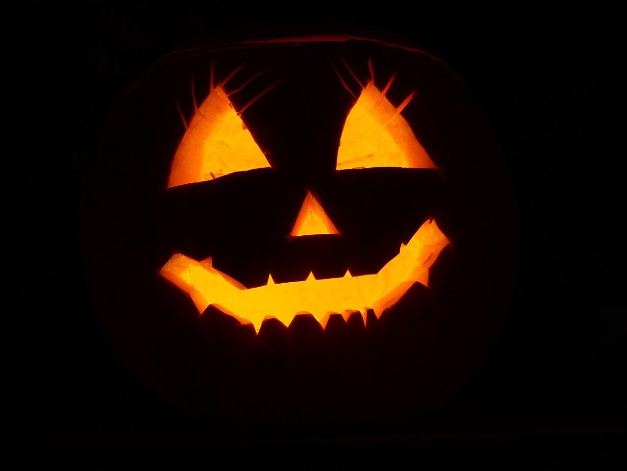 A Halloween jack-o-lantern glowing in the dark