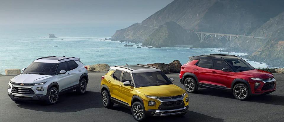 Three 2023 Chevy Trailblazers parked beside each other with a scenic background behind
