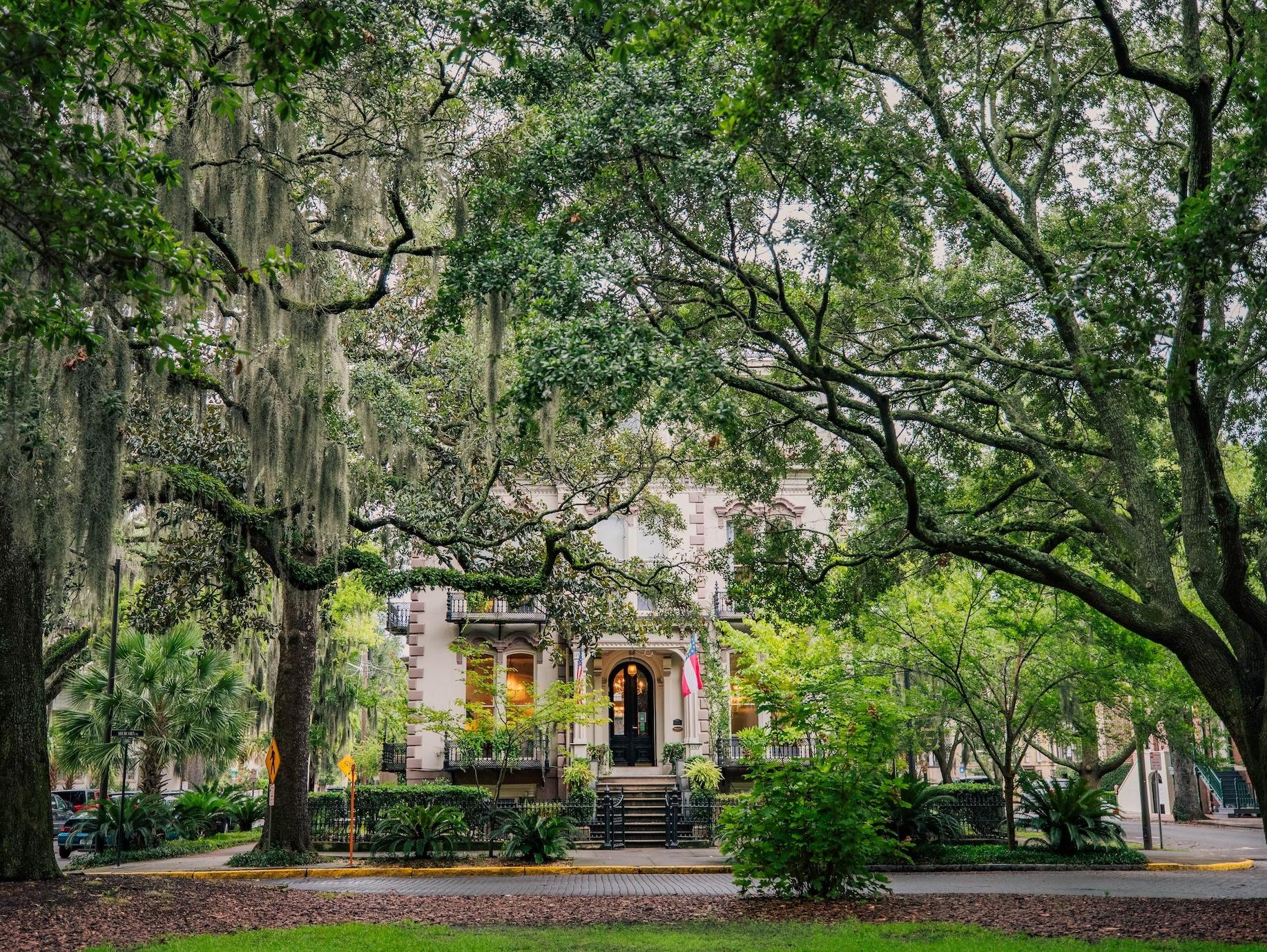 A park in front of a beautiful historic building in downtown Savannah, GA