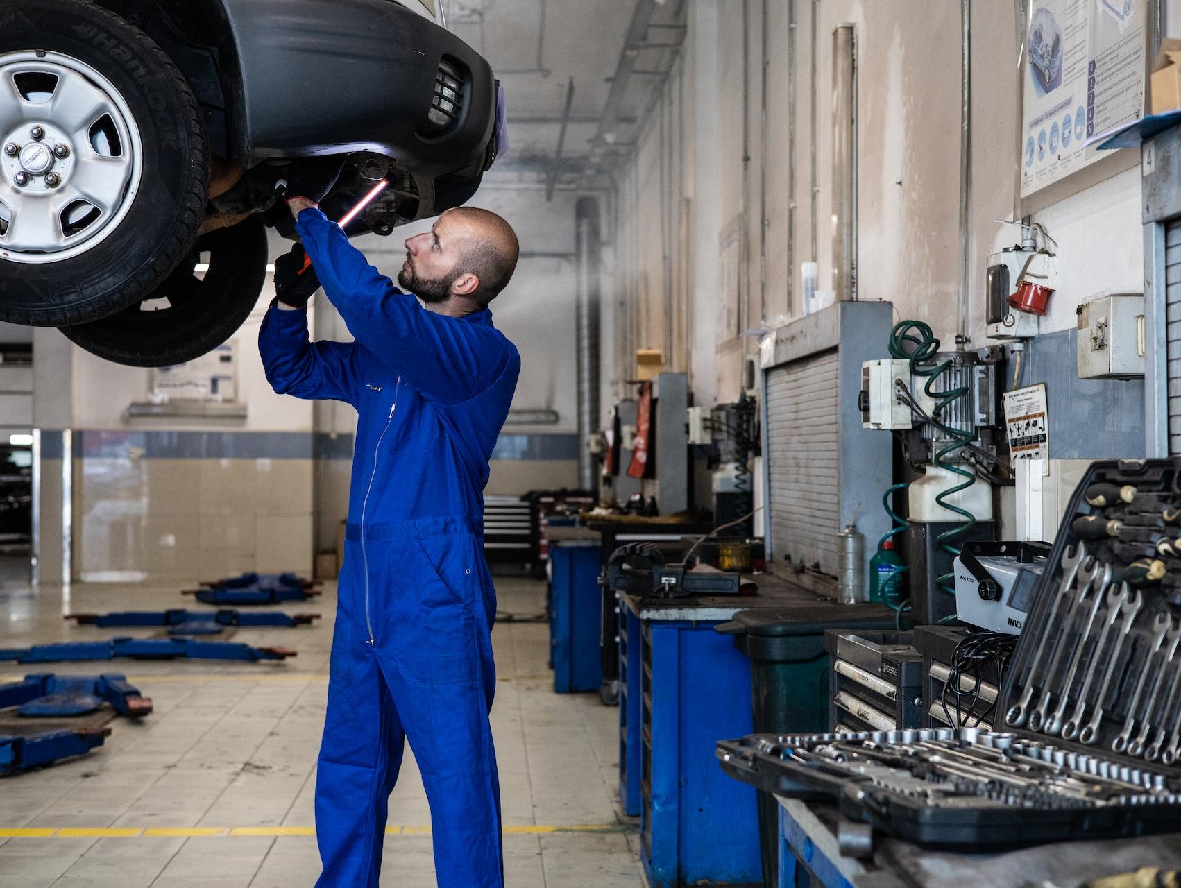mechanic performing a brake repair service on a vehicle