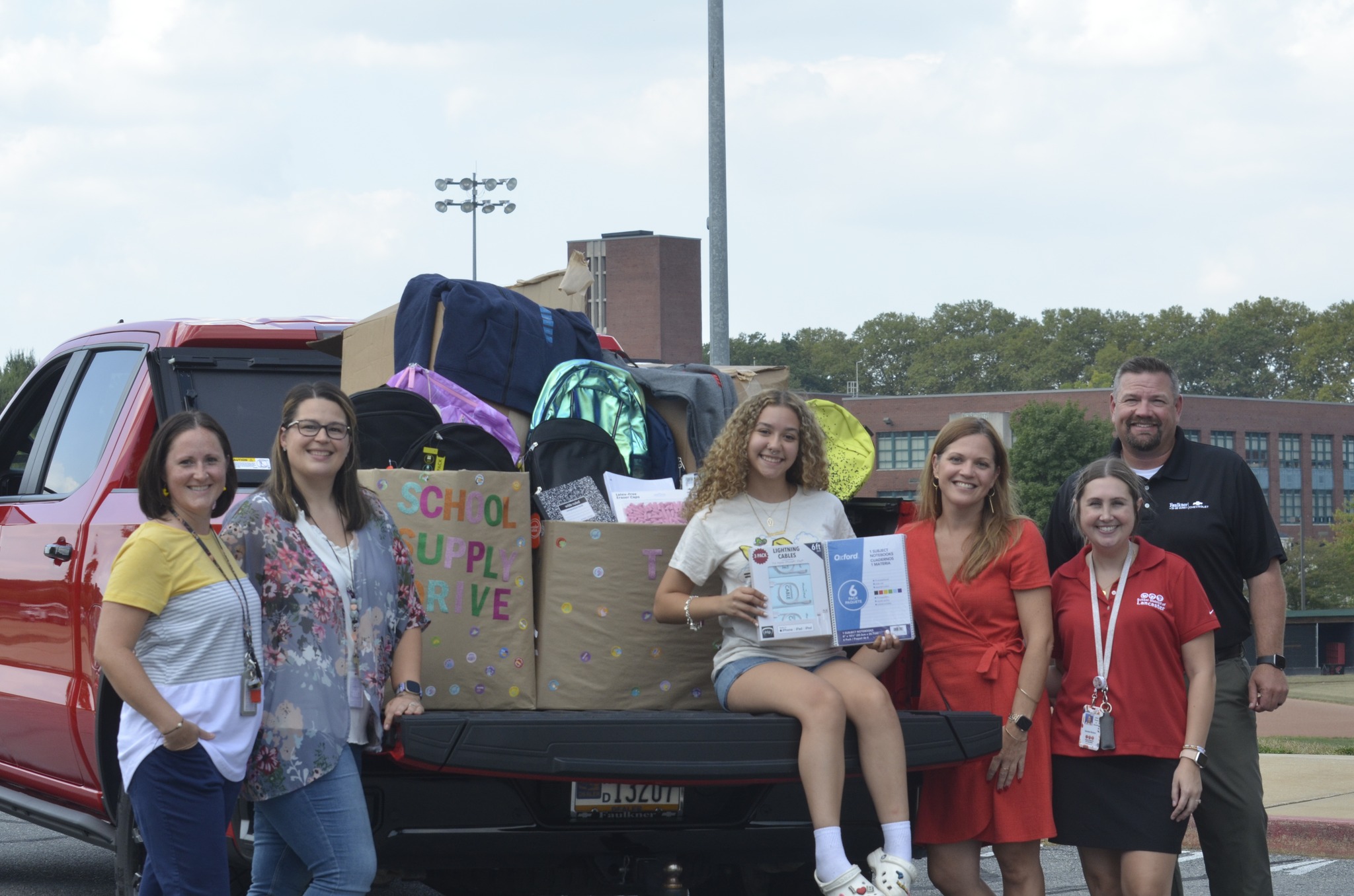 Faulkner Chevrolet's President & General Manager, Chad Berger (far right) stands with faculty and student ambassador during the drop off of items collected for the School Supply Drive