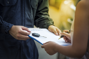 hanging paperwork and keys to new car owner