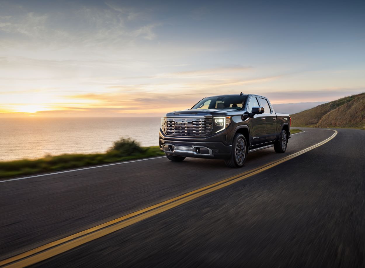 A 2024 GMC Sierra 1500 drives down the road.