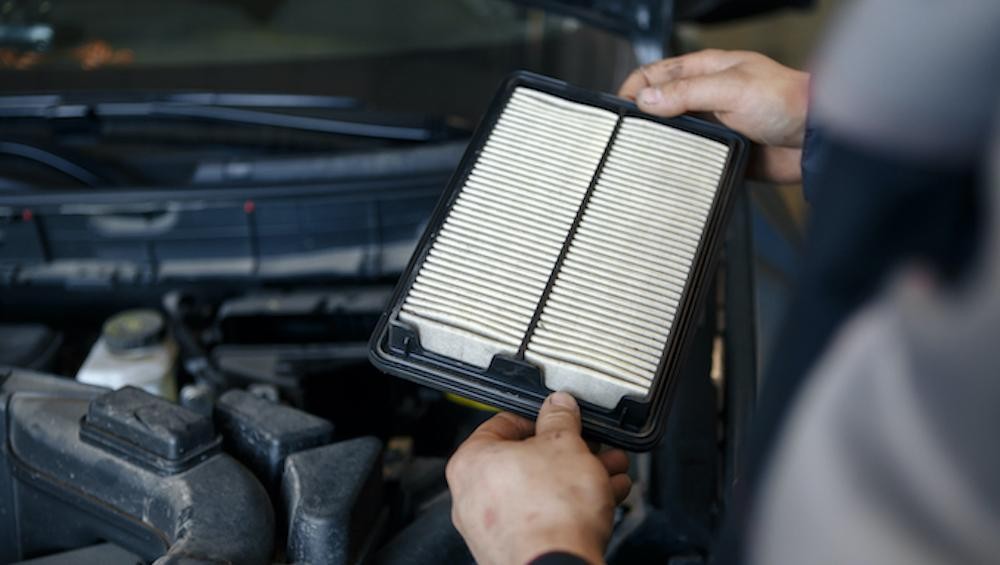 Technician replacing cabin air filter