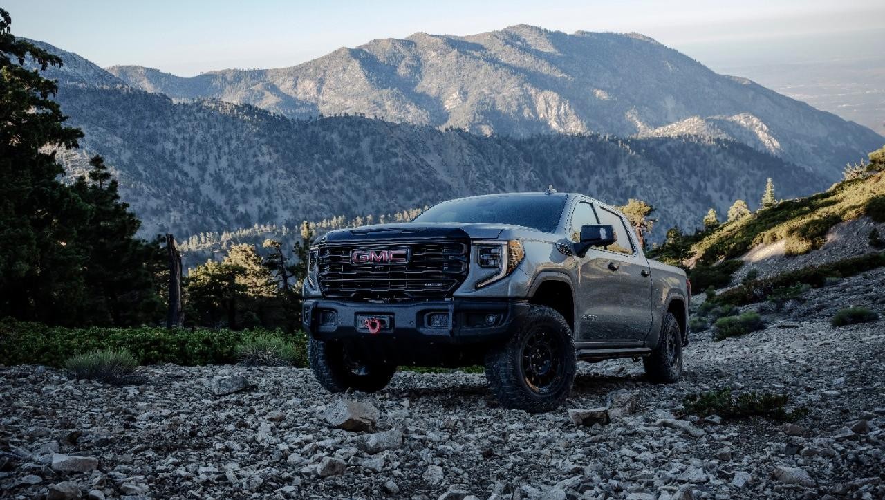 2023 GMC Sierra 1500 parked on rocks with mountain in background