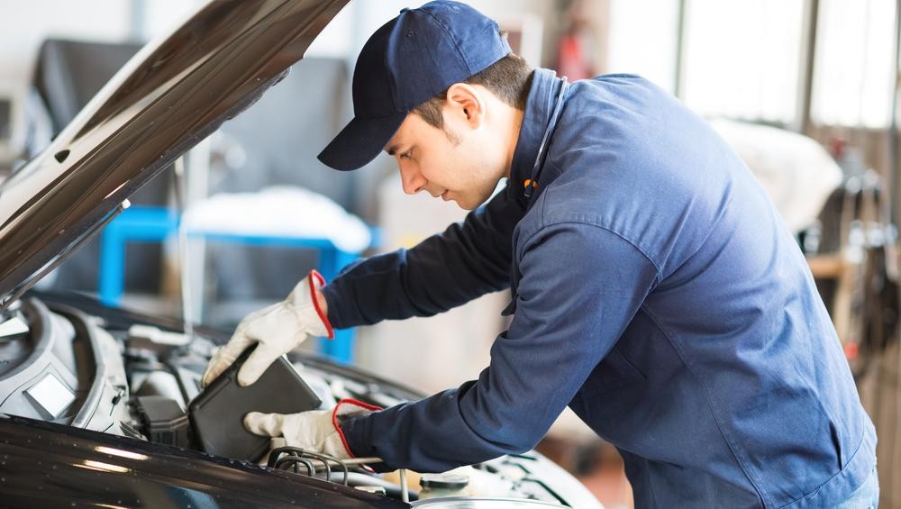 Maintenance Tech Replacing Engine Oil Maintenance Tech Replacing Engine Oil