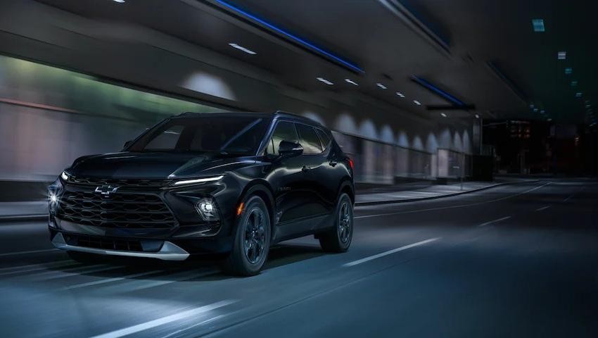 Black 2023 Chevy Blazer driving fast under a tunnel