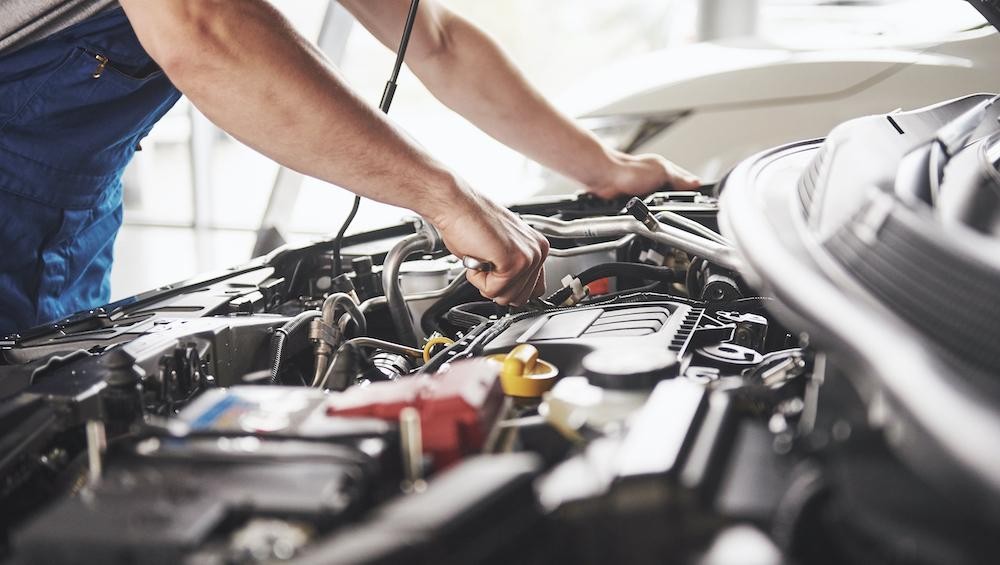 Technician working on engine of Chevy