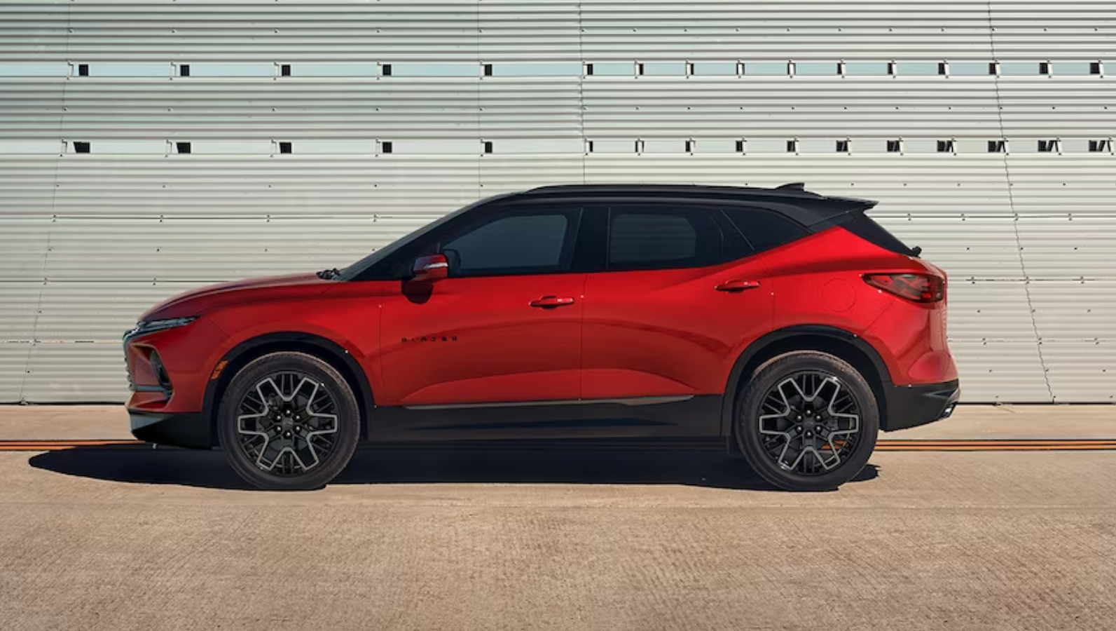 2024 Chevy Blazer parked in front of a steel wall