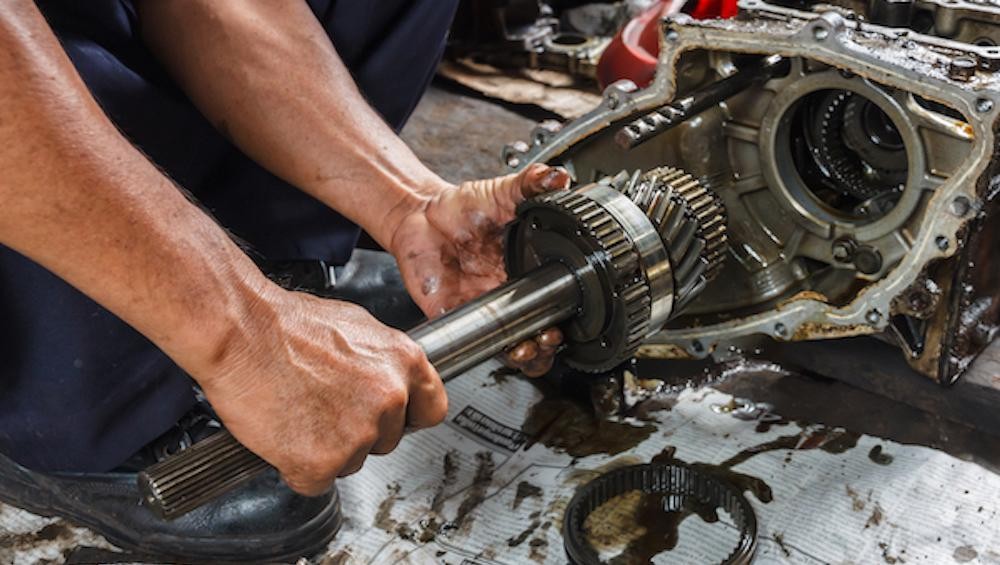 Technician putting in new transmission