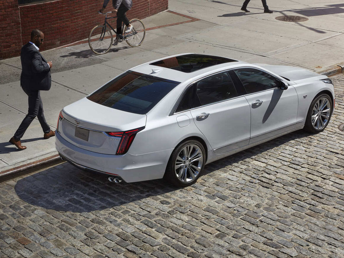 A certified pre-owned Cadillac is parked.