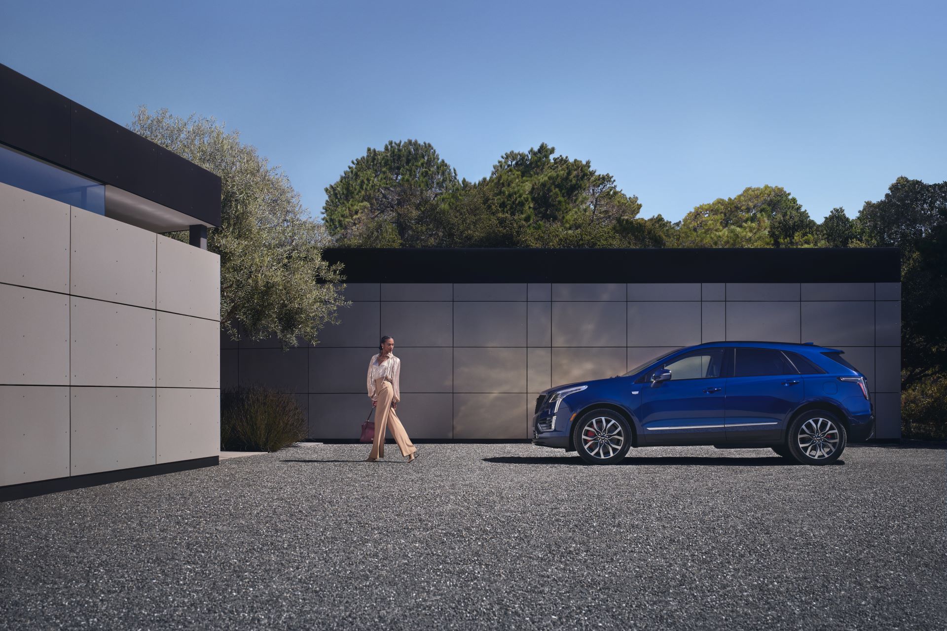 A blue 2024 Cadillac XT5 SUV is on display.