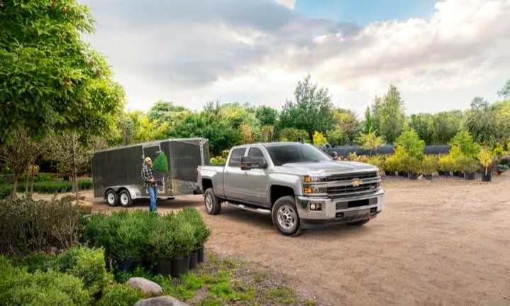 2019 Chevy Silverado 2500HD Towing a Trailer in a Tree Farm