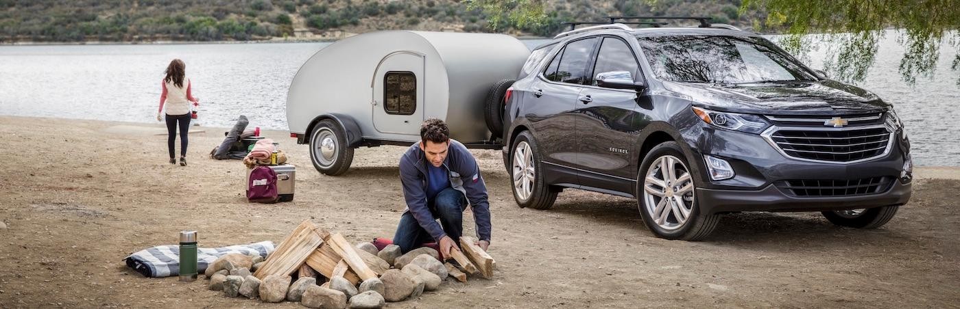 Navy Blue Chevy Equinox Pulling a Camper