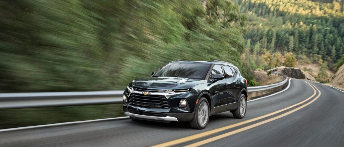 2019 Green Chevy Blazer Driving By Trees On A Highway 2019 Green Chevy Blazer Driving By Trees On A Highway