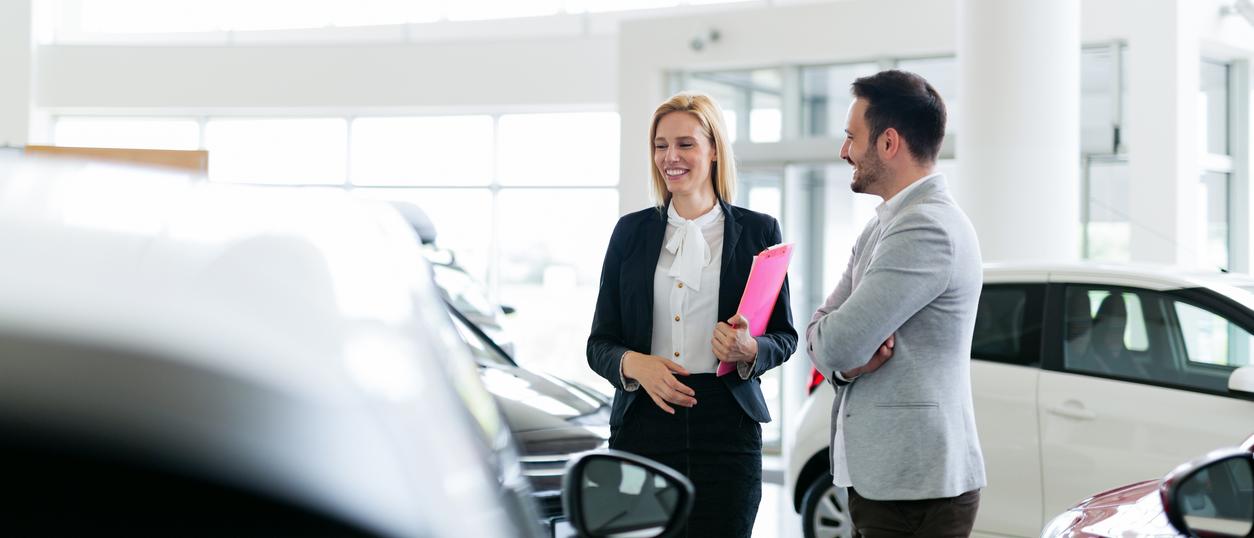 Man Asking Questions About A Car at Dealership