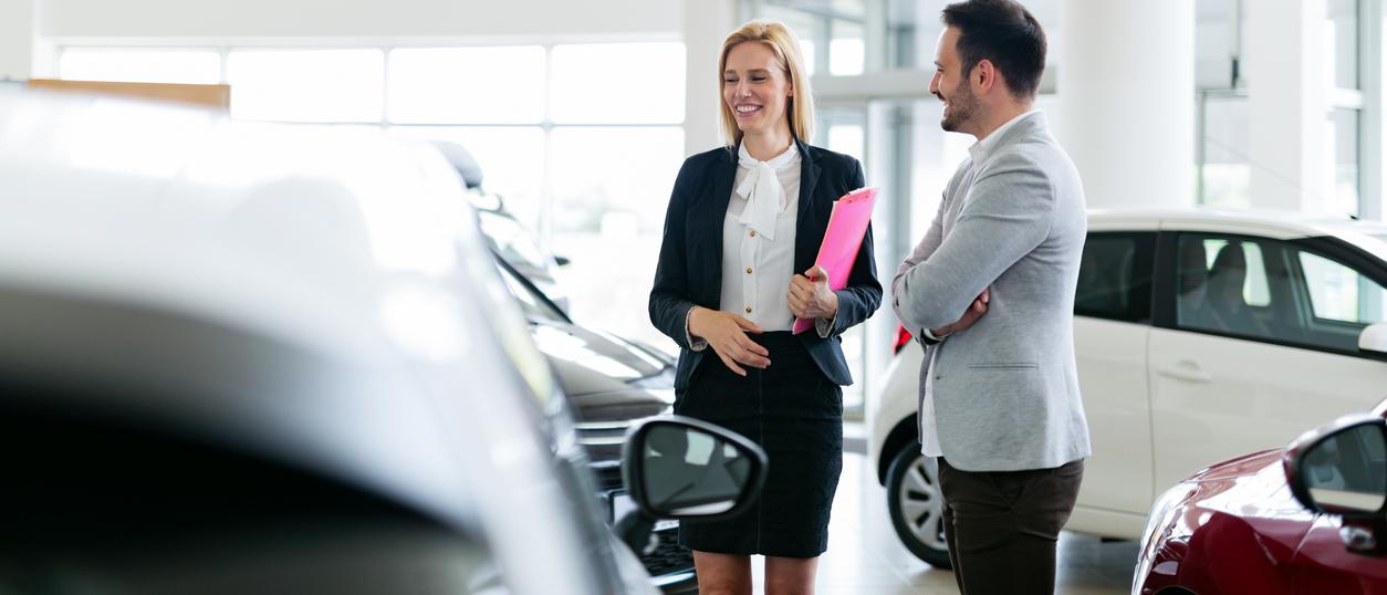 Man Asking Questions About A Car at Dealership