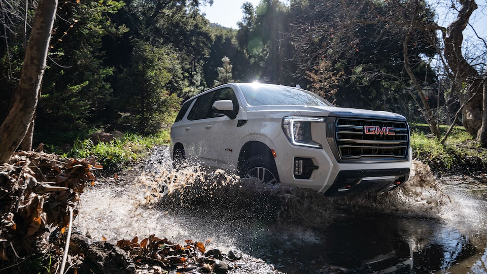 2023 GMC Yukon XL Driving Through Stream