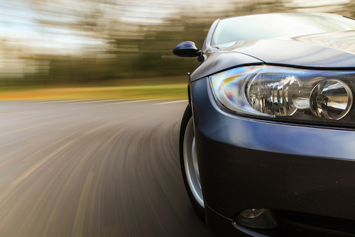 New car hugging the road on a curve