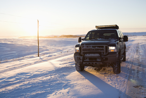 pickup truck traveling on a snowy road