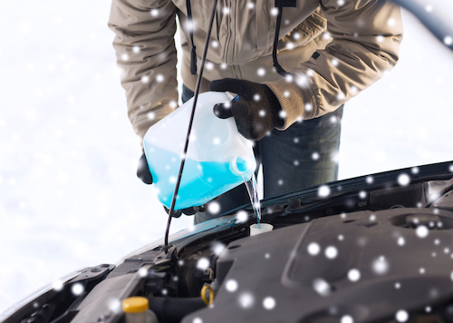 Man pouring antifreeze in his vehicle