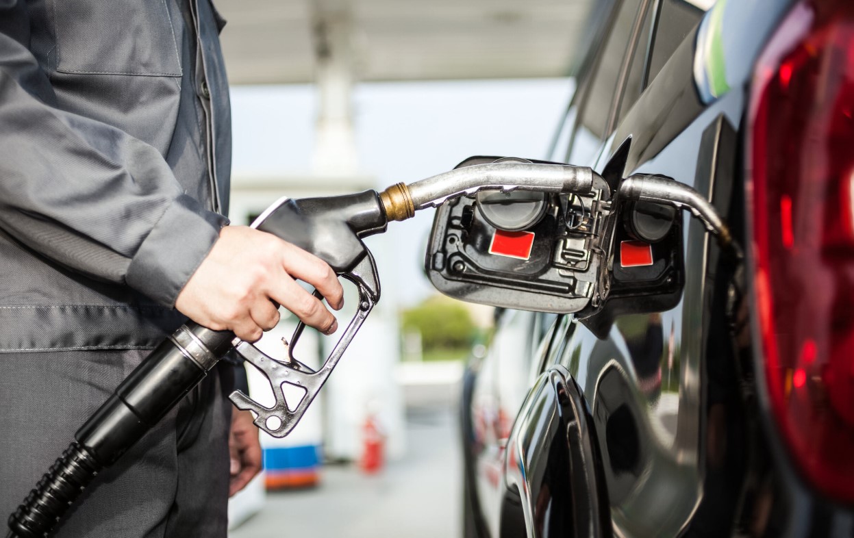 person filling up car with gas