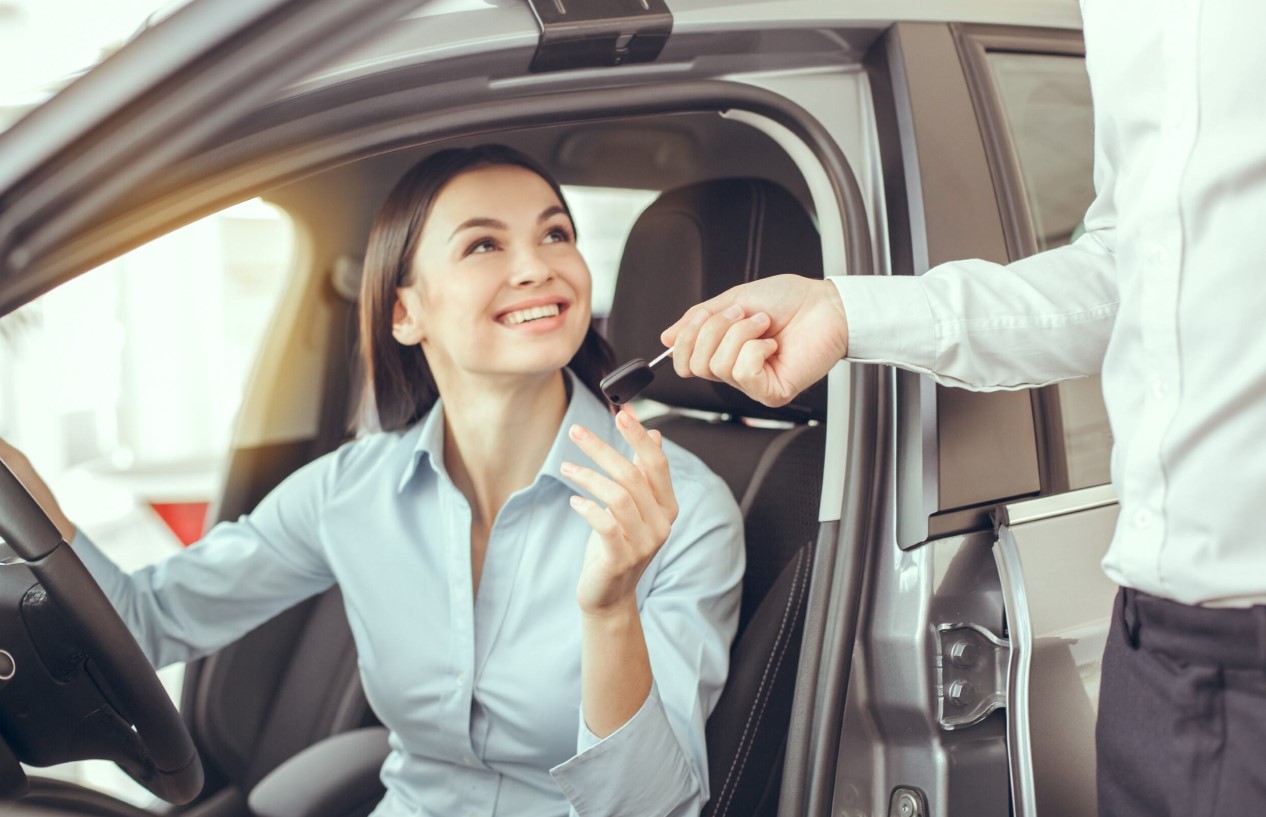 Woman driving pre-owned car