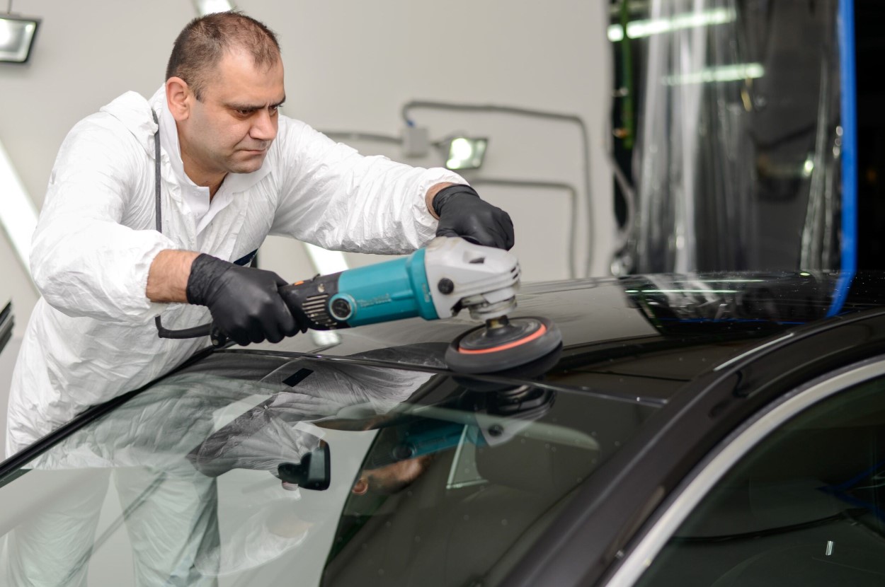 woman polishing a new car